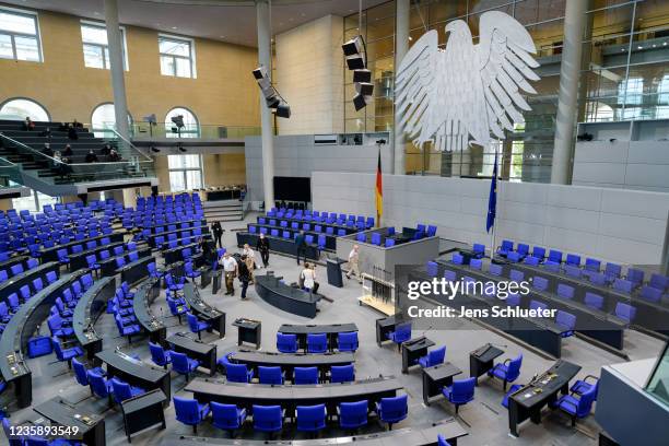 Workers rearrange chairs in the plenary hall of the Bundestag, Germany's parliament, to accommodate the new constellation of party mandates following...