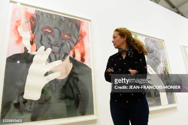 French visual artist Francoise Petrovitch poses next to "smoking", an ink wash on paper, during an exhibition devoted to her work at the Helene and...