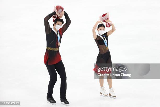 Gold medalist Wang Shiyue and Liu Xinyu of China celebrates during the medal ceremony after compete in the Ice dance free dance during the 2021 Asia...