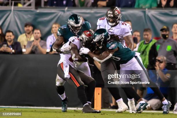 Tampa Bay Buccaneers wide receiver Chris Godwin is tackled by Philadelphia Eagles linebacker Davion Taylor and Philadelphia Eagles free safety...