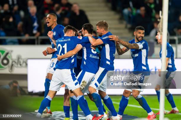 Malick Thiaw of FC Schalke 04 celebrates after scoring his team's first goal with teammates during the Second Bundesliga match between Hannover 96...