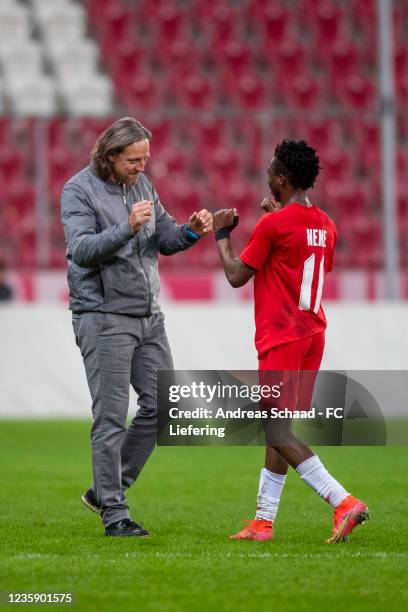 Coach Rene Aufhauser and Nene Dorgeles both of FC Liefering celebrate after the 2. Liga match between FC Liefering and FC Juniors Ooe at Red Bull...