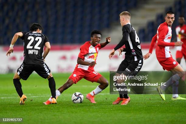 Inpyo Oh and Maco Alessandro Sulzner of FC Juniors Ooe and Nene Dorgeles of FC Liefering during the 2. Liga match between FC Liefering and FC Juniors...