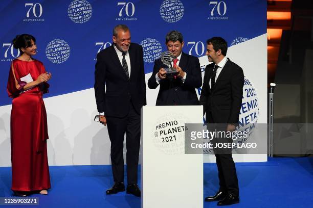 Winners of Spain's 2021 Premio Planeta award Jorge Diaz, Antonio Mercero and Augustin Martinez receive the trophy for their novel "La Bestia",...