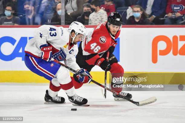 Xavier Ouellet of the Laval Rocket and Pontus Åberg of the Belleville Senators skate after the puck during the third period at Place Bell on October...
