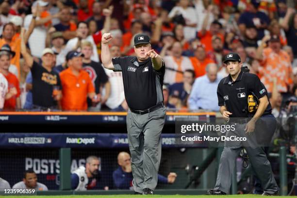 First Base Umpire Bill Miller singles out after a FTX Replay Review in the sixth inning during Game 1 of the ALCS between the Boston Red Sox and the...