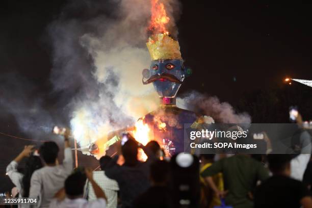 People watch the burning of an effigy of demon Kumbhakarna, during the festival. Hindu festival of Dussehra at Lav Kush Ramlila. The 10 days are also...