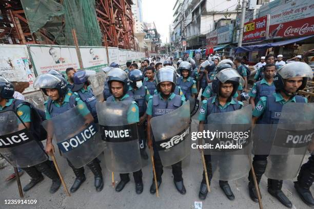 Police officers stand guard as Bangladesh Islamist political party take part in a protest outside the National Mosque after alleged âdishonouringâ...