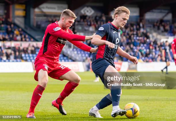 Ross County's Alex Samuel competes with Marcus Fraser during a cinch Premiership match between Ross County and St Mirren at the Global Energy...