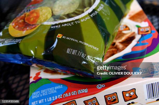 This photo illustration shows an 11-ounce bag of Tostitos tortilla chips and an 18.8-ounce box of General Mills' Cinnamon Toast Crunch on October 15...