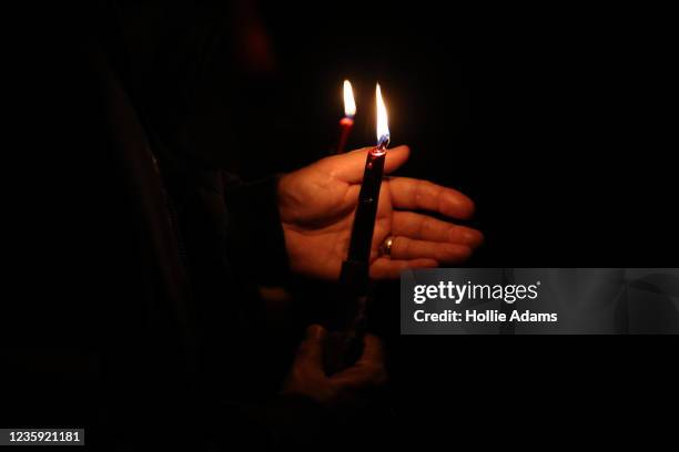 Members of the public light candles in memory of MP Sir David Amess at Belfairs Sports Ground on October 16, 2021 in Leigh-on-Sea, United Kingdom....