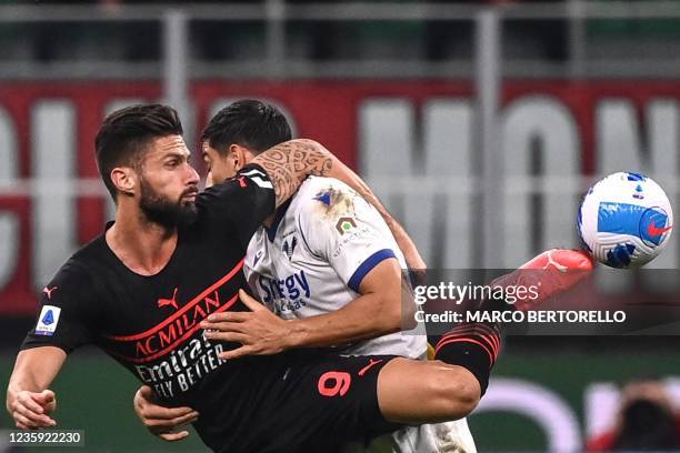 Milan's French forward Olivier Giroud and Hellas Verona's German defender Koray Gunter go for the ball during the Italian Serie A football match...