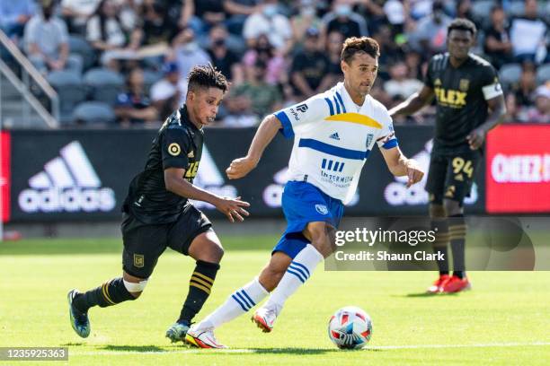 Chris Wondolowski of San Jose Earthquakes battles Latif Blessing of Los Angeles FC during the match at Banc of California Stadium on October 16, 2021...