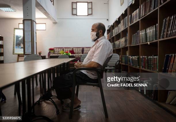 Saleh, a prisoner who has been languishing in Moroccan jails for 19 years on terrorism charges, sits at the library inside the prison of Kenitra, in...