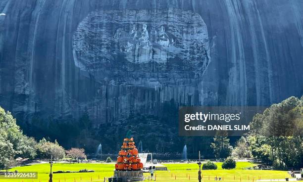 Pumpkins are displayed in front of the carving of three Confederate leaders, Stonewall Jackson, Robert E. Lee and Jefferson Davis, at Stone Mountain...