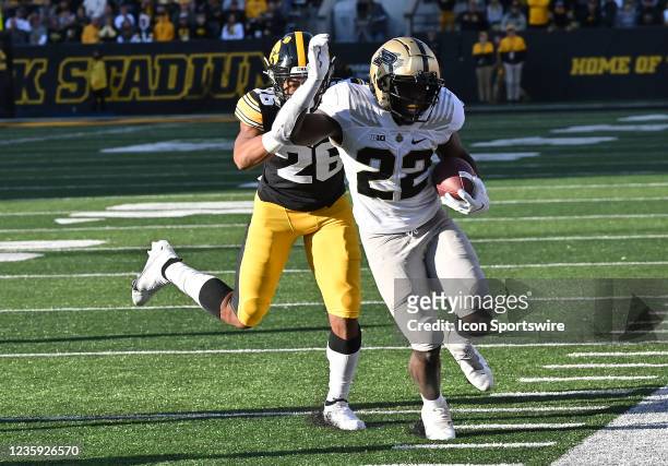 Purdue running back King Doerue Jr runs for the sideline as Iowa strong safety Kaevon Merriweather pursues during a college football game between the...