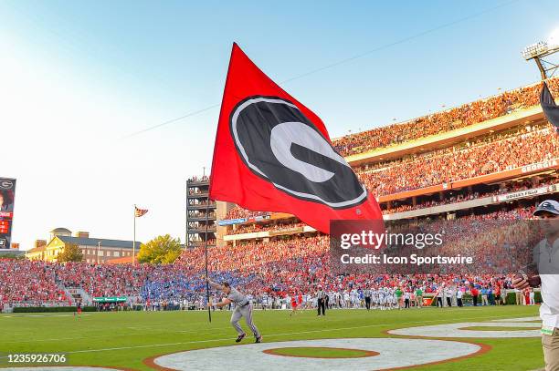 Georgia cheerleader runs with a flag during the college football game between the Kentucky Wildcats and the Georgia Bulldogs on October 16th, 2021 at...