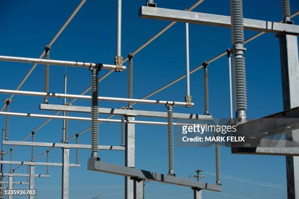 Power lines for the new Bitcoin mining warehouses under construction at the Whinstone US Bitcoin mining facility in Rockdale, Texas, on October 9,...