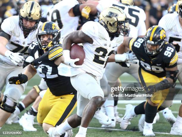 Running back King Doerue of the Purdue Boilermakers runs up the field in the second half between defensive lineman John Waggoner and defensive...