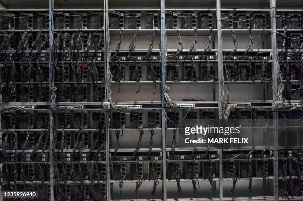 Row of Bitcoin mining machines at the Whinstone US Bitcoin mining facility in Rockdale, Texas on October 9, 2021. - The long sheds at North America's...