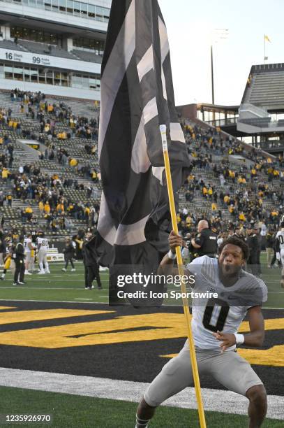 Purdue wide receiver Milton Wright celebrates with a team banner after winning a college football game between the Purdue University Boilermakers and...