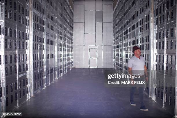 Whinstone CEO Chad Harris poses for a portrait in a room with Bitcoin mining machines during a tour at the Whinstone US Bitcoin mining facility in...