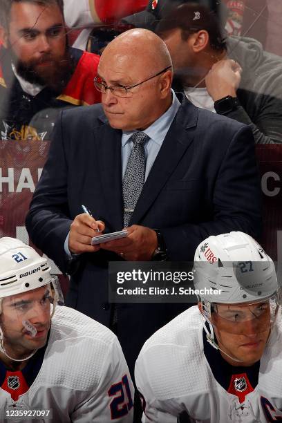 New York Islanders Head Coach Barry Trotz makes a few notes during a break in the action against the Florida Panthers at the FLA Live Arena on...