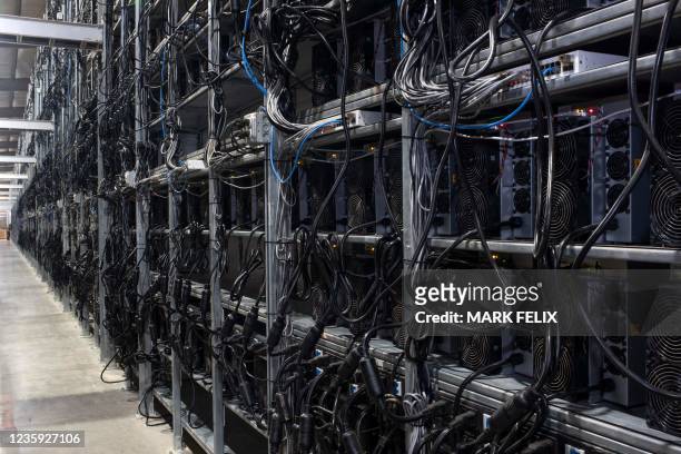 Bitcoin mining machines in a warehouse at the Whinstone US Bitcoin mining facility in Rockdale, Texas, on October 10, 2021. - The long sheds at North...