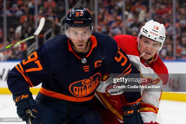 Connor McDavid of the Edmonton Oilers skates against Matthew Tkachuk of the Calgary Flames during the third period at Rogers Place on October 16,...