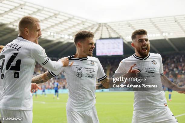 Jamie Paterson of Swansea City celebrates his goal with Jake Bidwell and Ryan Manning during the Sky Bet Championship match between Swansea City and...