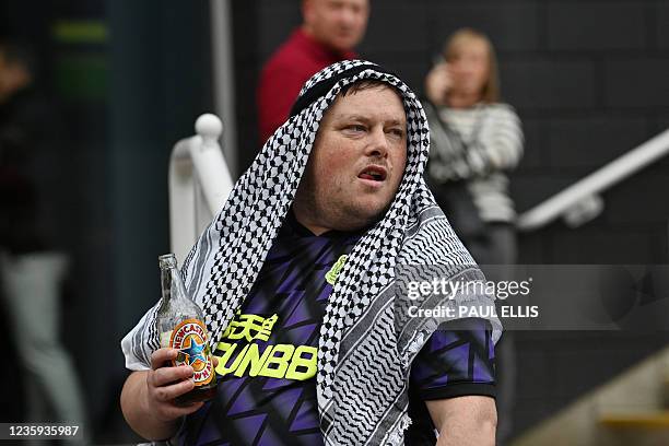 Newcastle United fan wears a headress as he arrives at St James' Park in Newcastle-upon-Tyne, north east England on October 17, 2021 for the English...