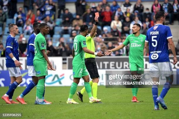 French referee Mikael Lesage gives a red card to Saint-Etiennes French midfielder Zaydou Youssouf during the French L1 football match between RC...