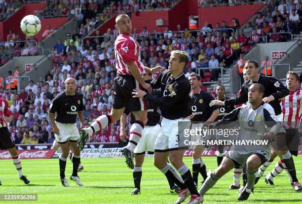 Southampton's Kevin Phillips jumps for a high ball amidst the defense of Manchester United, 31 August 2003 at Southampton's new ground during their...