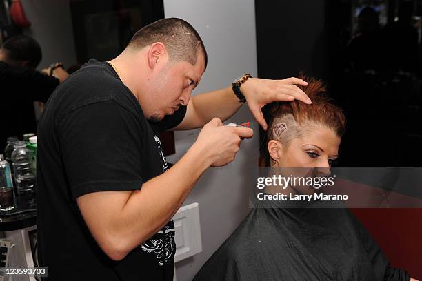 Joslyn James gets a new hair style at the Hall Of Fame barber shop on April 22, 2011 in Miami Beach, Florida.