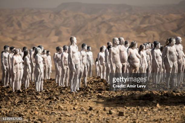 Nude models pose for a photograph as American artist Spencer Tunick's photo installation is unveiled on October 17, 2021 in Arad, Israel. Around 300...