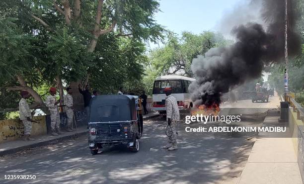 Sudanese security forces intervene as smoke billows from tyres set on fire by Sudanese students demonstrating against the hikes in bread prices due...