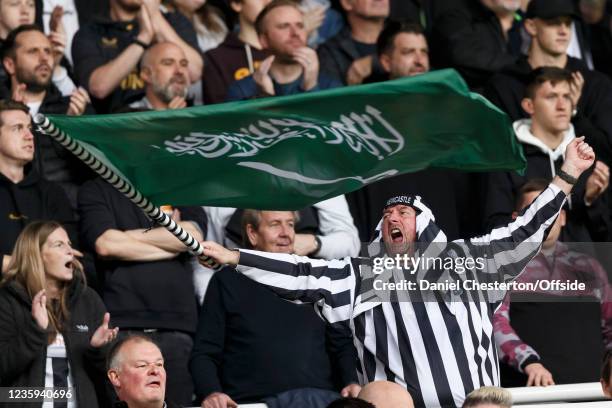 Newcastle United fan waves a Saudi Arabian flag during the Premier League match between Newcastle United and Tottenham Hotspur at St. James Park on...