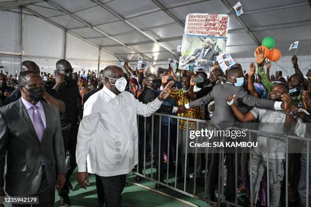 Former Ivorian President Laurent Gbagbo waves to supporters during the closure of the constituent congress of his new party Parti des Peuples...