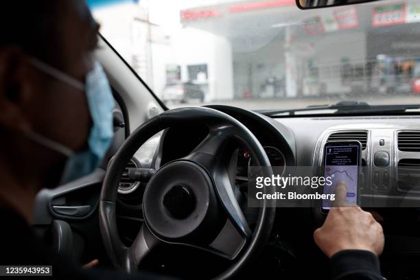 An Uber driver uses a smartphone for navigation in Sao Paulo, Brazil, on Sunday, Oct. 17, 2021. Uber is now allowing some users in Brazil to pay more...
