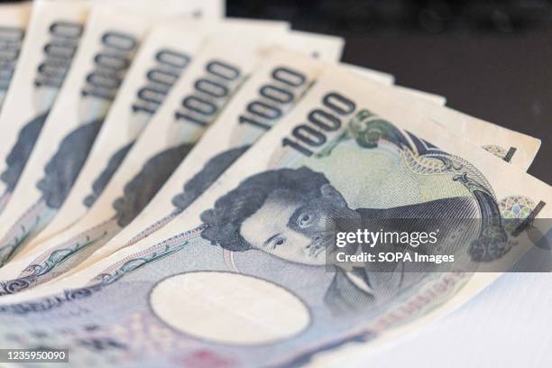 In this photo illustration the one thousand yen banknotes seen displayed.