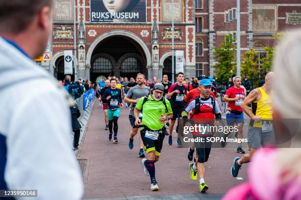 Runners are seen coming out of the passage of the Rijksmuseum. Last year, the marathon was canceled due to the coronavirus, but with 31,000...