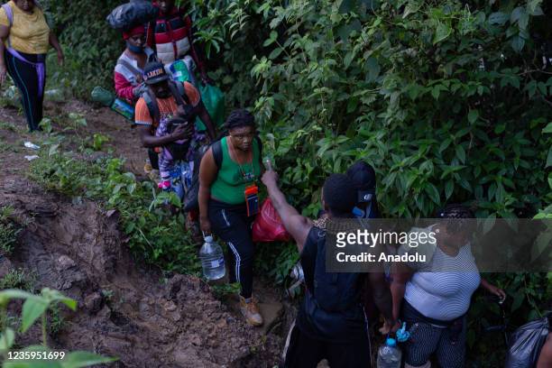Migrants, most of them Haitians, cross the dangerous border between Panama and Colombia daily, taking their families with them, children, partners,...