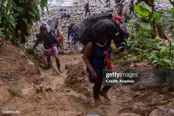 Migrants, most of them Haitians, cross the dangerous border between Panama and Colombia daily, taking their families with them, children, partners,...