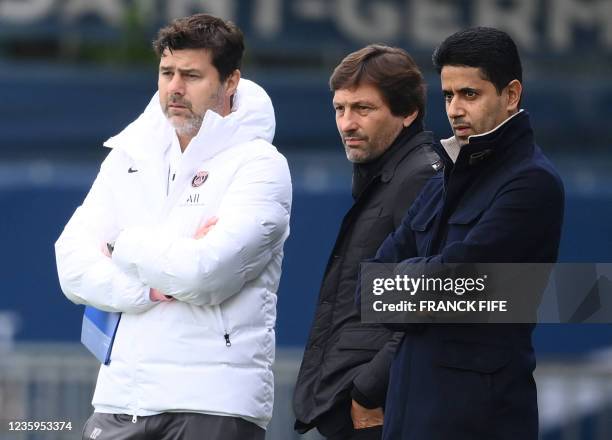 Paris Saint-Germain's Qatari president Nasser Al-Khelaifi looks on next to Paris Saint-Germain's Argentinian head coach Mauricio Pochettino and...