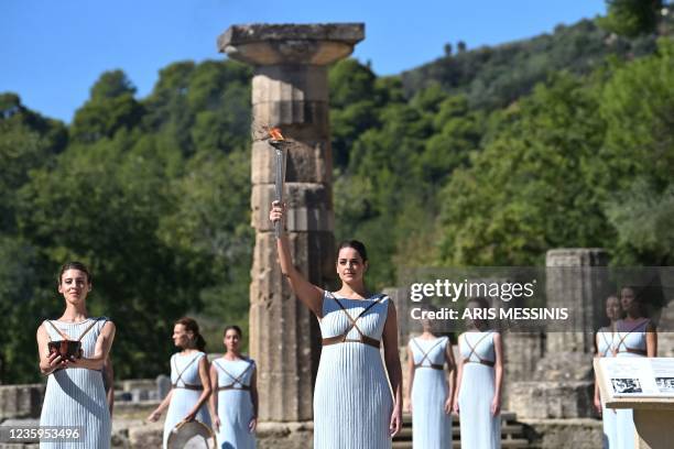 Greek actress Xanthi Georgiou , playing the role of the High Priestess, holds up the lit torch during the flame lighting ceremony for the Beijing...