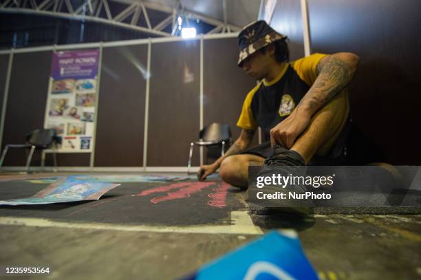Artists make murals alusive to movies and comics on the ground during the fourth day of the SOFA 2021, a fair aimed to the geek audience in Colombia...
