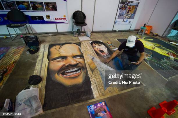 Artists make murals alusive to movies and comics on the ground during the fourth day of the SOFA 2021, a fair aimed to the geek audience in Colombia...