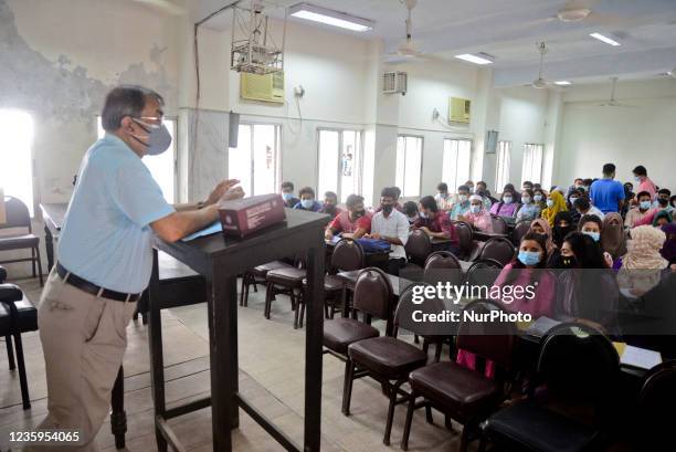 Dhaka University students wearing face masks attend their class after one and half year reopened maintaining Covid-19 guidelines and health protocols...