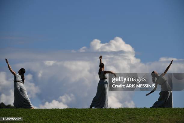 Actresses playing the role of a Priestess, perform during the flame lighting ceremony for the Beijing 2022 Winter Olympics at the Ancient Olympia...