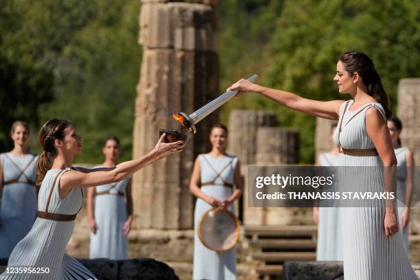 Greek actress Xanthi Georgiou, playing the role of the High Priestess, lights the torch during the flame lighting ceremony for the Beijing 2022...